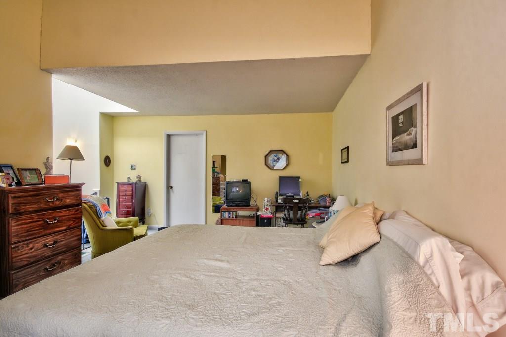 4331 Lake Ridge Drive, Unit NONE Raleigh, NC 27604 - Photo 11 of 14 a bed room with a bed and a chair
