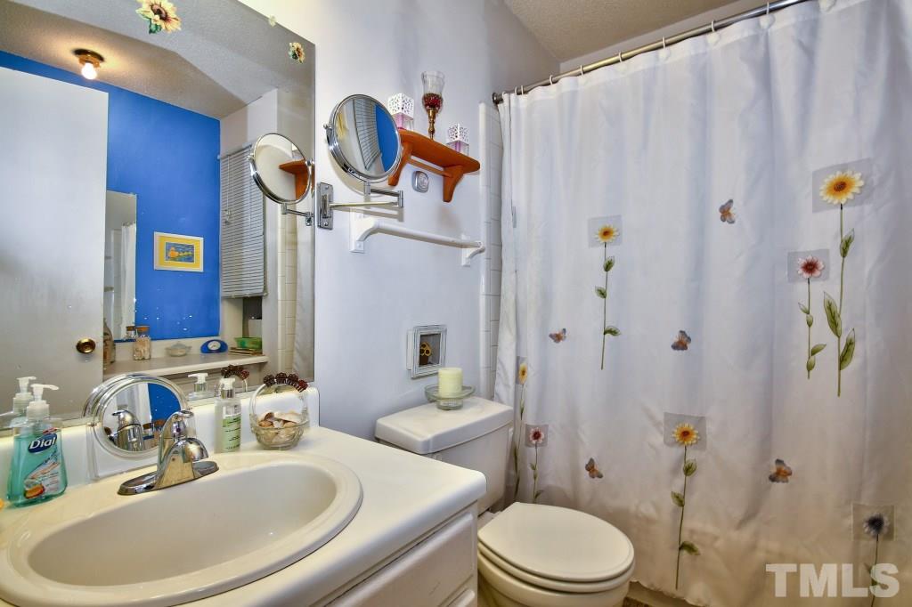 4331 Lake Ridge Drive, Unit NONE Raleigh, NC 27604 - Photo 12 of 14 a bathroom with a sink a toilet and shower