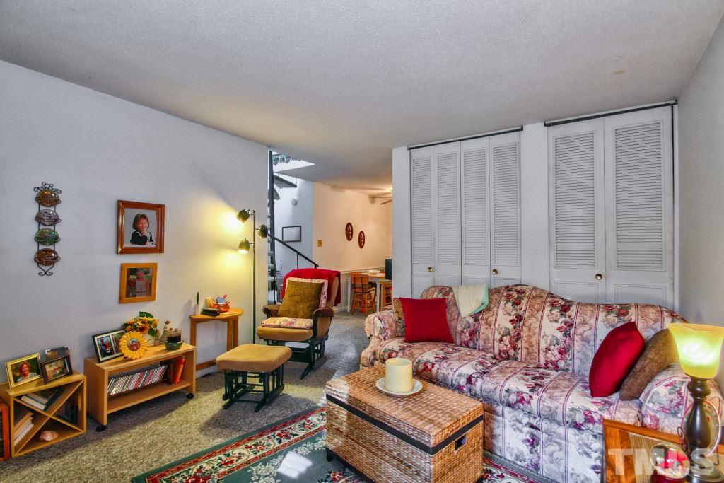 4331 Lake Ridge Drive, Unit NONE Raleigh, NC 27604 - Photo 5 of 14 a living room with furniture and wooden floor