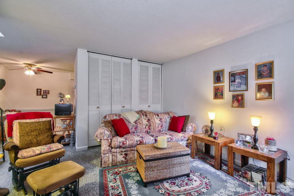 4331 Lake Ridge Drive, Unit NONE Raleigh, NC 27604 - Photo 6 of 14 a living room with furniture a rug and a lamp