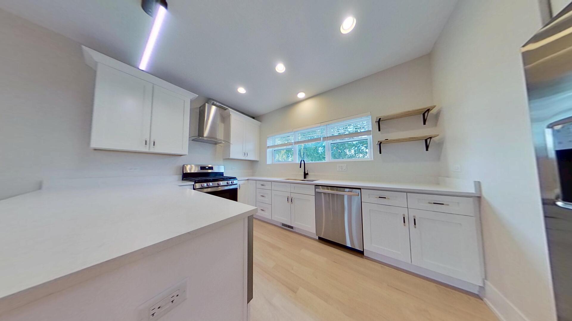 4000 Forest Avenue, Unit 2 Brookfield, IL 60513 - Photo 2 of 15 a kitchen with granite countertop white cabinets and white appliances