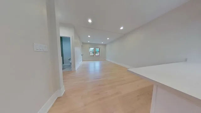 en empty room with wooden floor