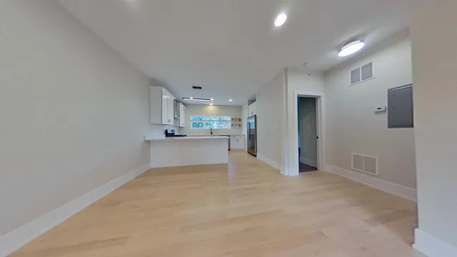 a view of a kitchen with a sink and cabinets