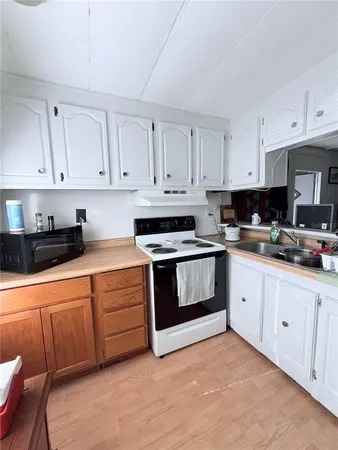 a kitchen with stainless steel appliances granite countertop a sink and a refrigerator