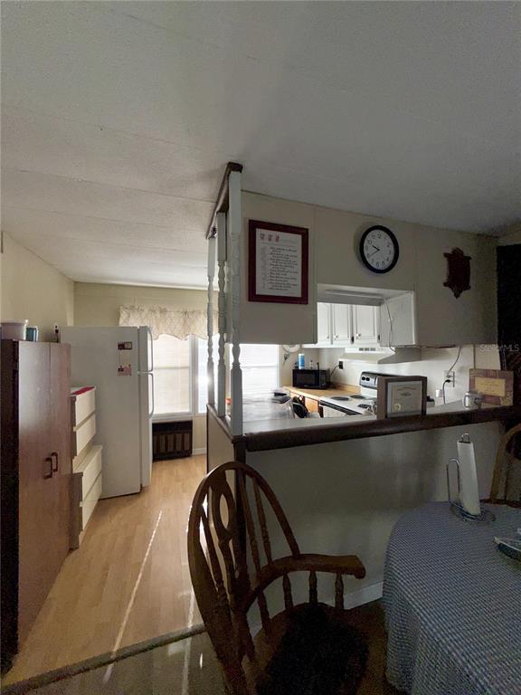 1370 County Drive Tavares, FL 32778 - Photo 5 of 12 a kitchen with stainless steel appliances granite countertop a sink and a refrigerator
