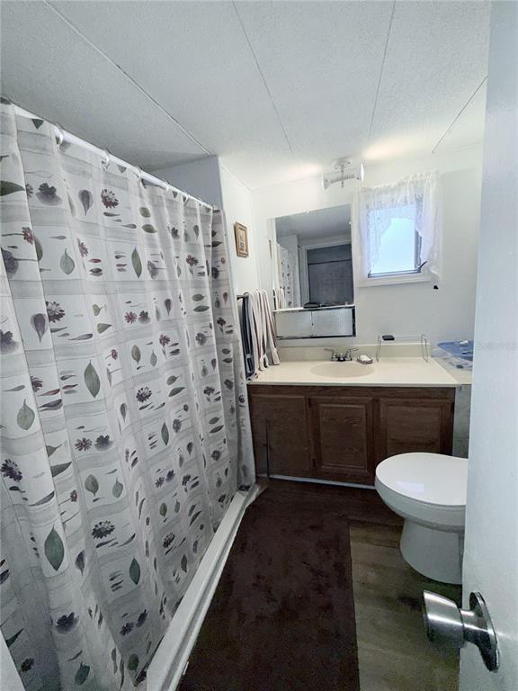 1370 County Drive Tavares, FL 32778 - Photo 8 of 12 a bathroom with a sink toilet and a mirror