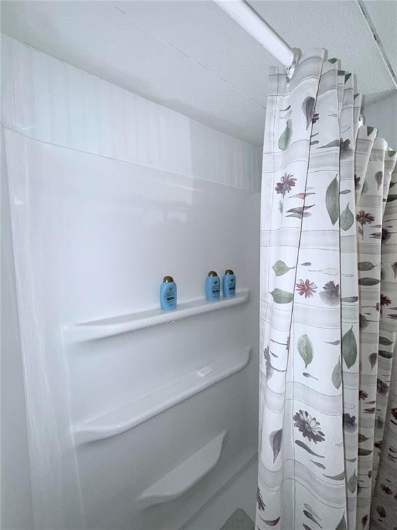1370 County Drive Tavares, FL 32778 - Photo 9 of 12 a bathroom with a shower curtain