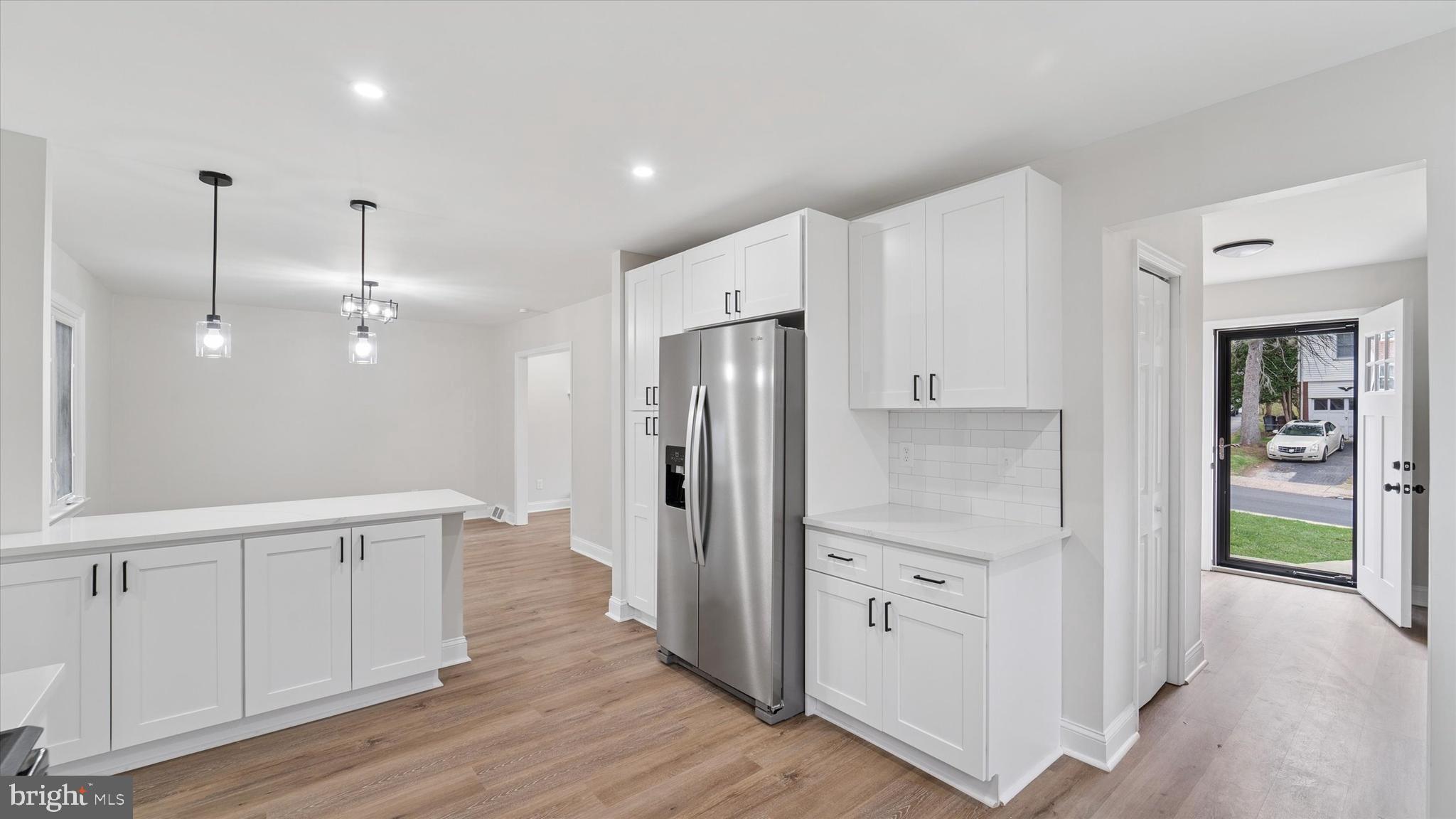 21 Fairview Road Springfield, PA 19064 - Photo 12 of 25 a kitchen with white cabinets and wooden floor