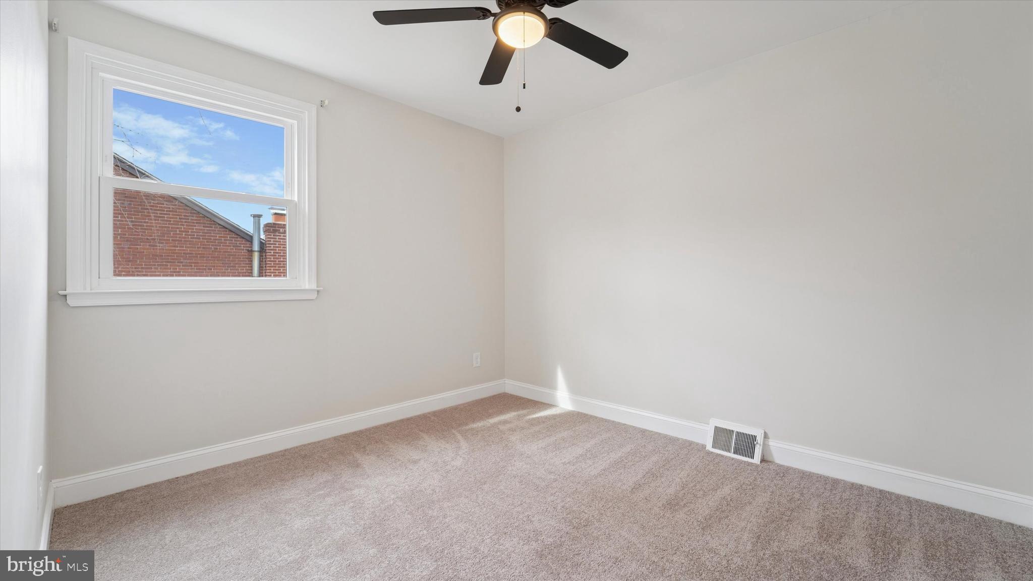 21 Fairview Road Springfield, PA 19064 - Photo 16 of 25 an empty room with a window and a ceiling fan