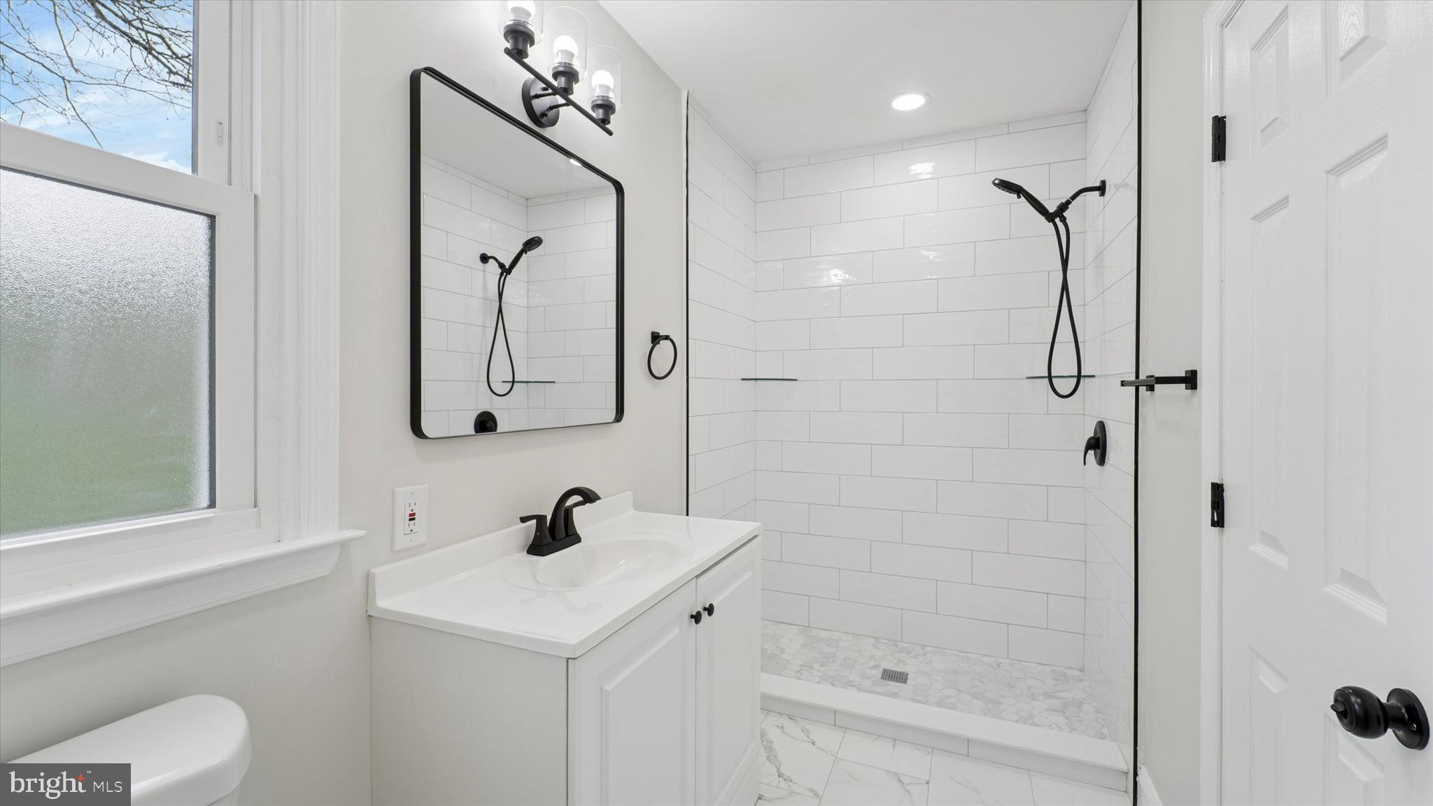 21 Fairview Road Springfield, PA 19064 - Photo 21 of 25 a bathroom with a sink a toilet and shower