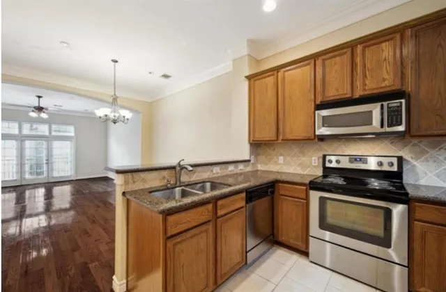 a kitchen that has a sink and a stove top oven