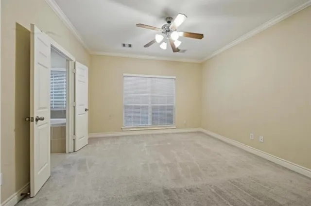an empty room with chandelier fan