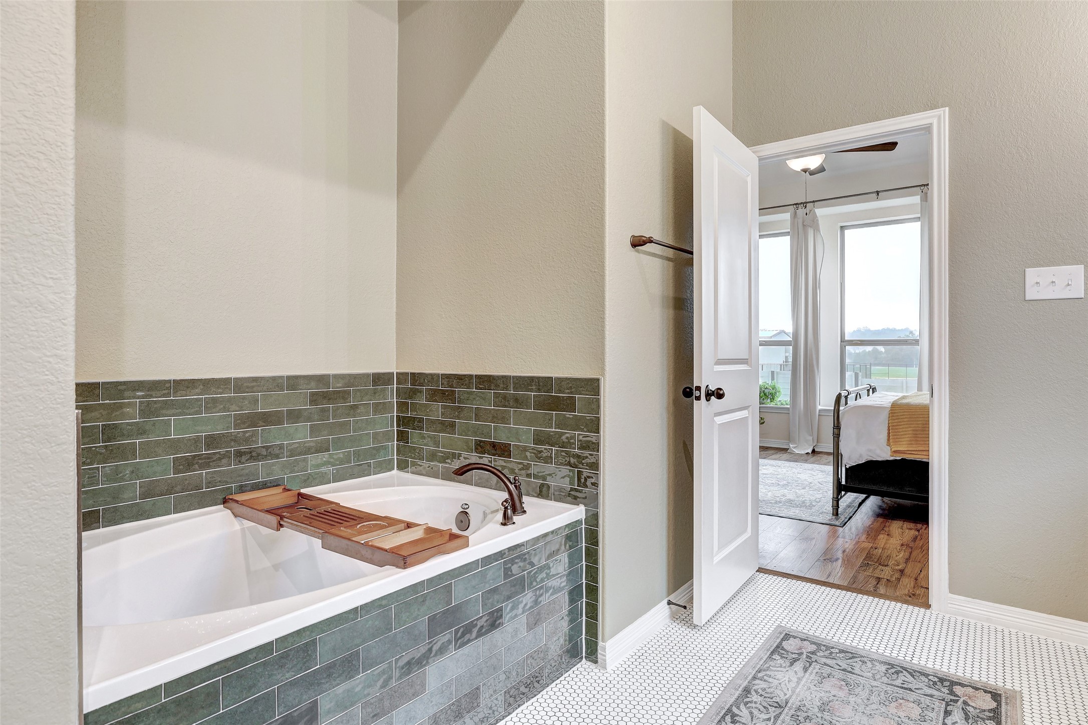 1117 Spring Gulch Lane Georgetown, TX 78628 - Photo 25 of 39 A deep soaking tub with decorative tile surround offers a relaxing escape within the primary bathroom.