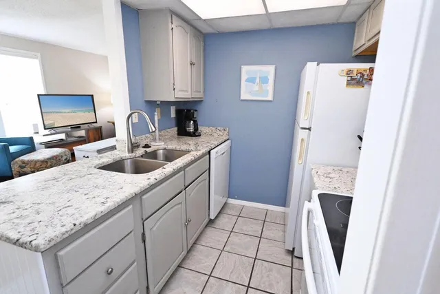 a kitchen with a refrigerator sink and stove