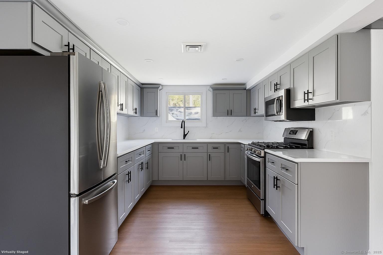 18 Pautipaug Hill Road Baltic, CT 06330 - Photo 17 of 35 a kitchen with white cabinets and appliances
