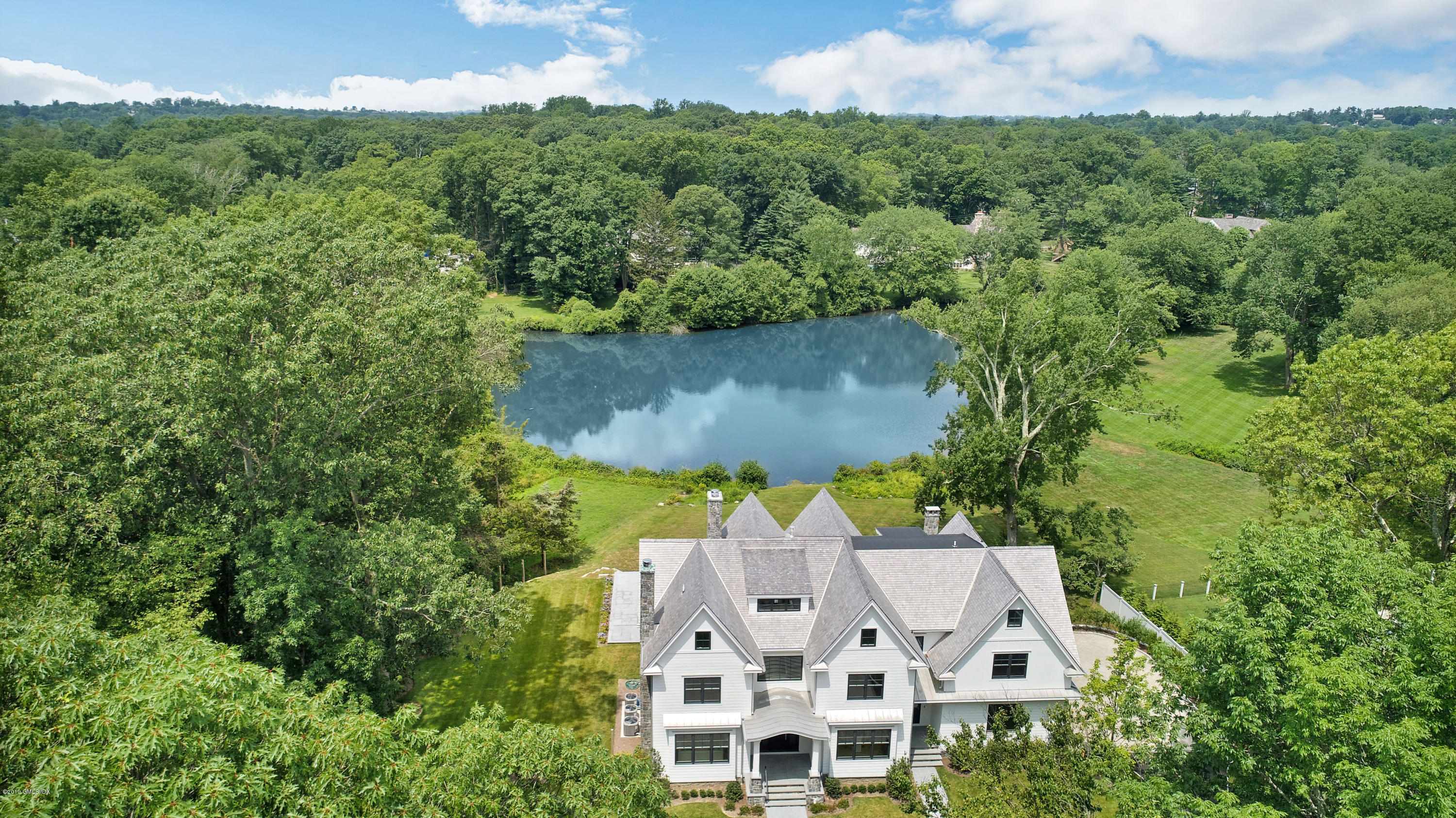 38 Birch Lane Greenwich, CT 06830 - Photo 1 of 31 an aerial view of a house with a yard and large tree