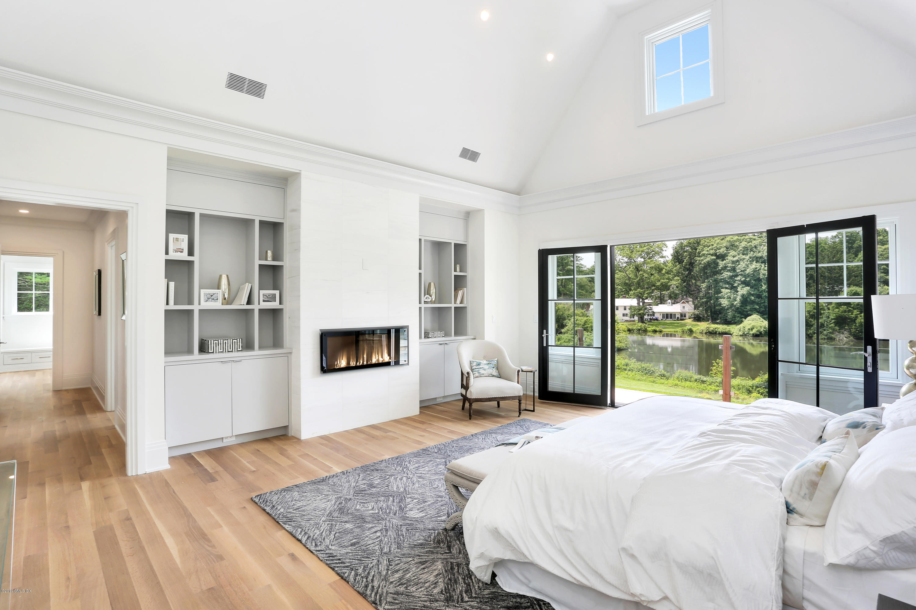 38 Birch Lane Greenwich, CT 06830 - Photo 17 of 31 a bedroom with a bed and large window with outer view