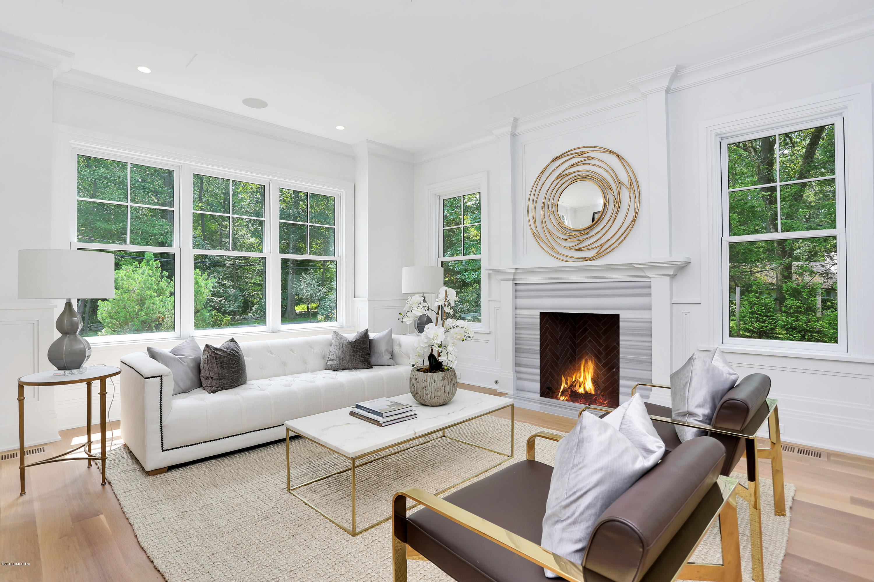 38 Birch Lane Greenwich, CT 06830 - Photo 5 of 31 a living room with furniture a fireplace and a large window