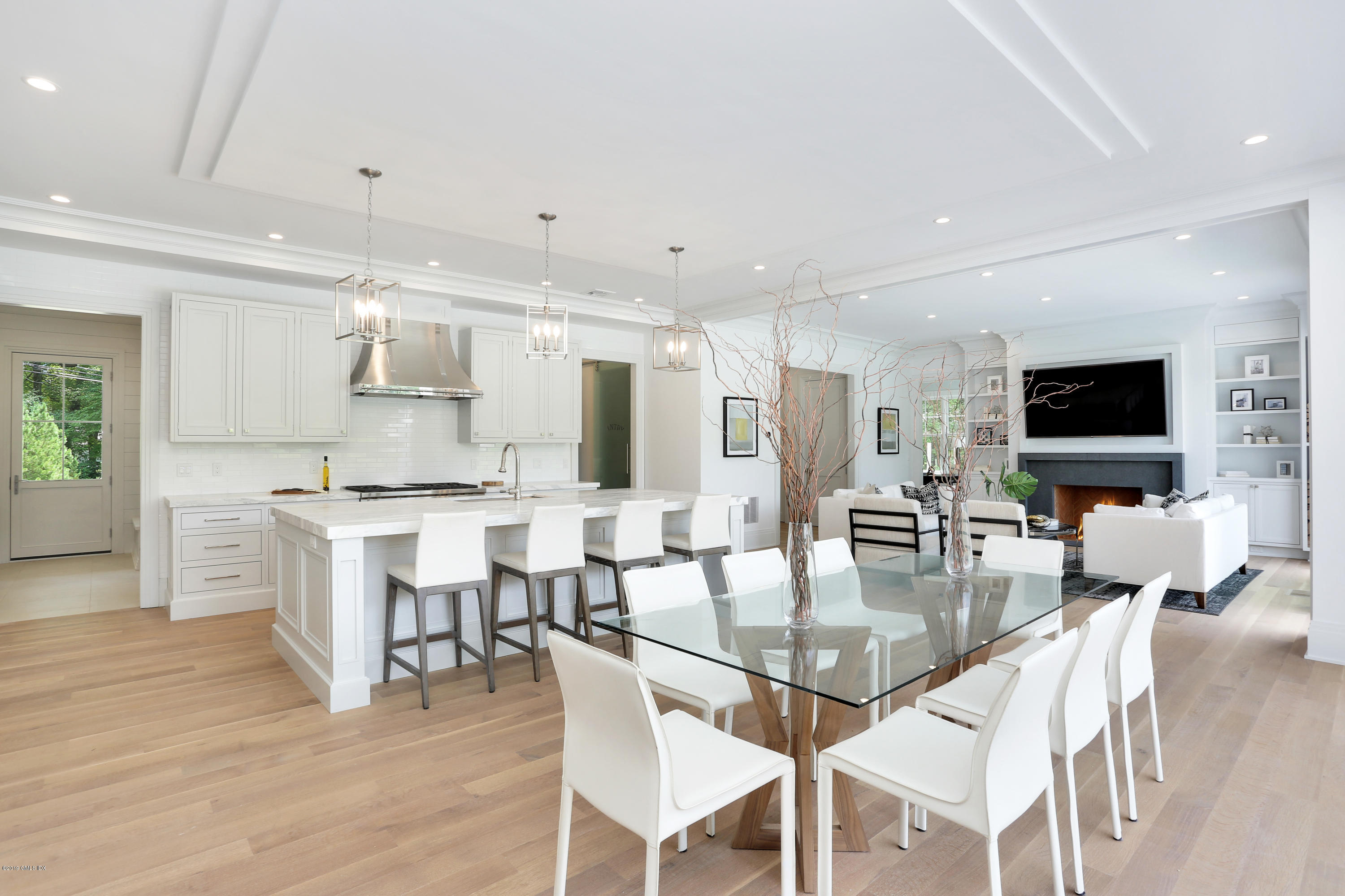 38 Birch Lane Greenwich, CT 06830 - Photo 10 of 31 a dining room with stainless steel appliances kitchen island granite countertop a table chairs and a view of living room