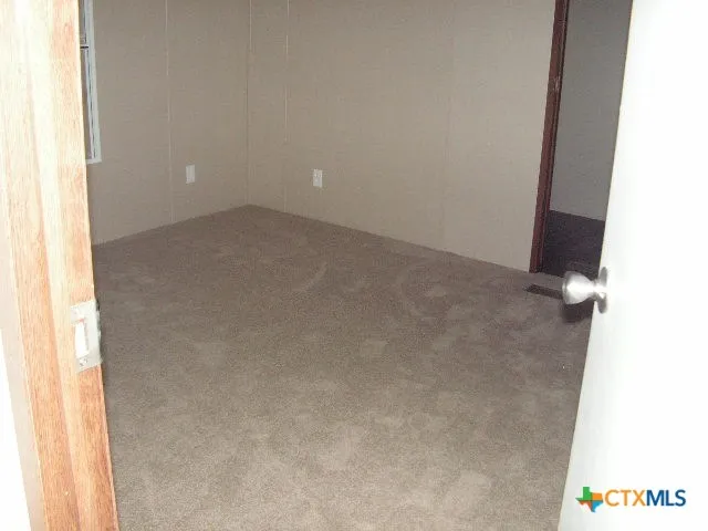 view of an empty room and a window