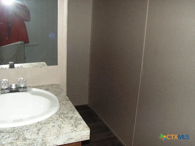 a bathroom with a sink and a mirror
