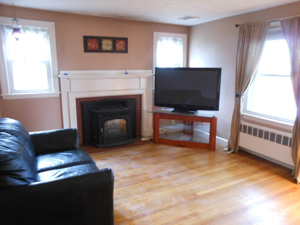 3 Outlook Road Waltham, MA 02451 - Photo 5 of 15 a living room with furniture and a fireplace