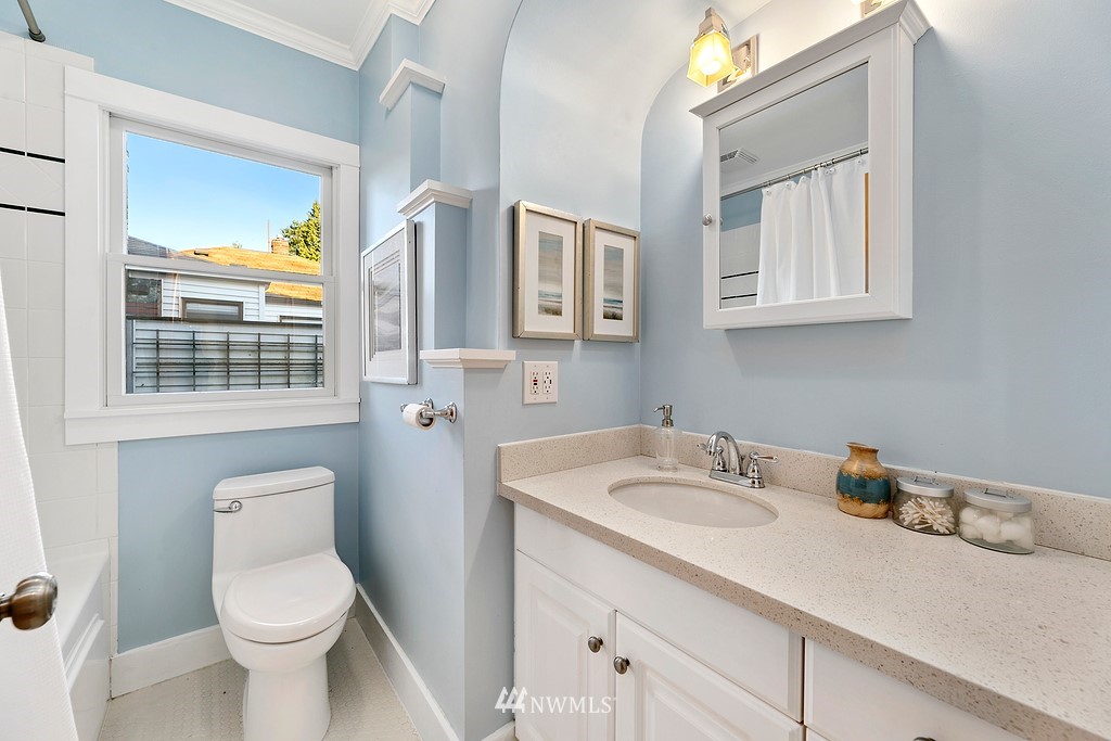 9547 Phinney Avenue North Seattle, WA 98103 - Photo 12 of 33 a bathroom with a toilet sink and mirror