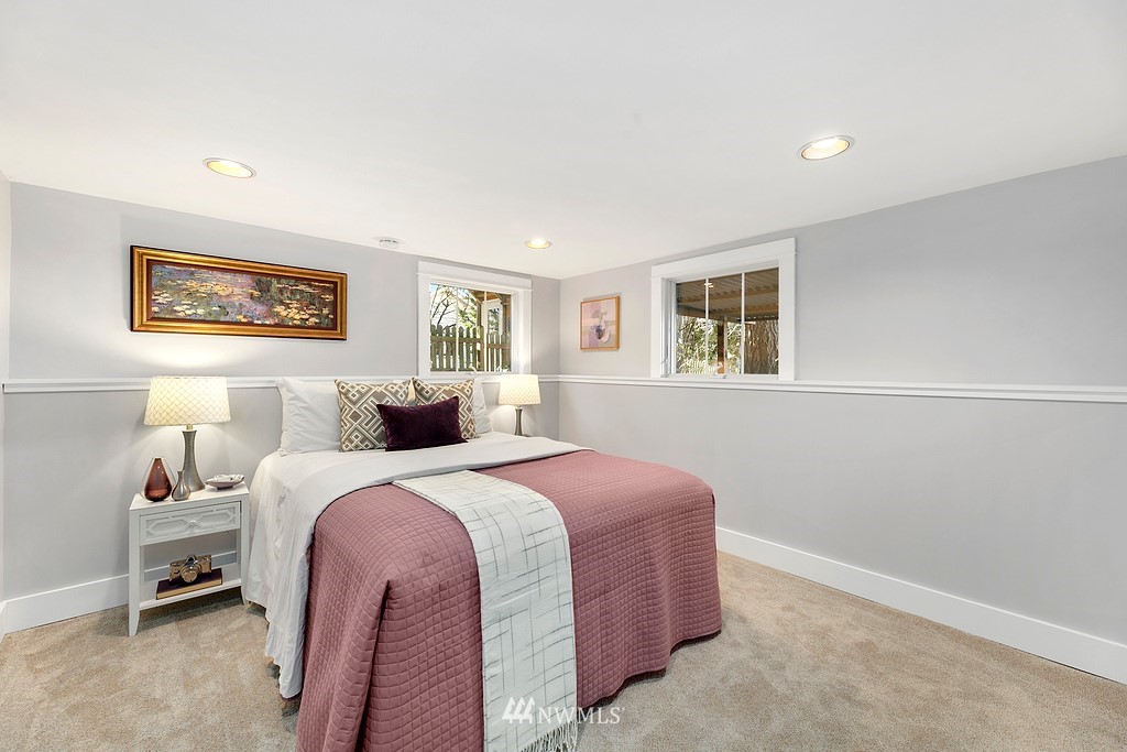 9547 Phinney Avenue North Seattle, WA 98103 - Photo 22 of 33 a spacious bedroom with a bed and a window
