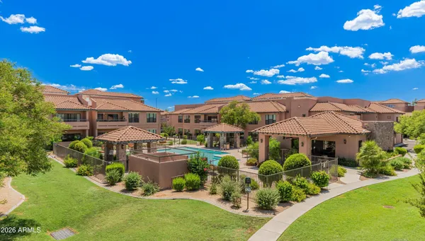a front view of a house with yard and swimming pool