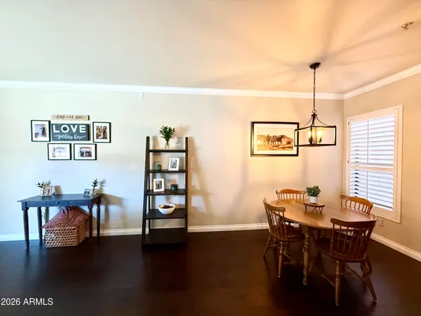 a dining room with furniture and wooden floor
