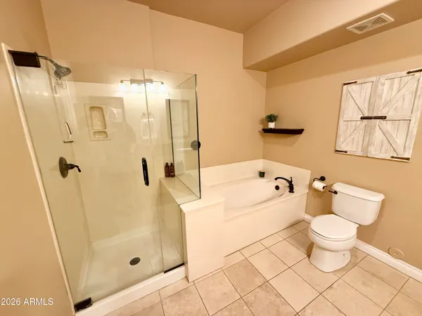 a bathroom with a bath tub a toilet and a shower