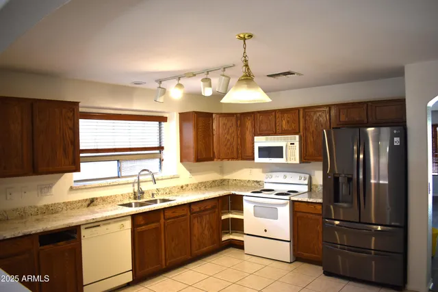 a kitchen with a refrigerator stove and sink