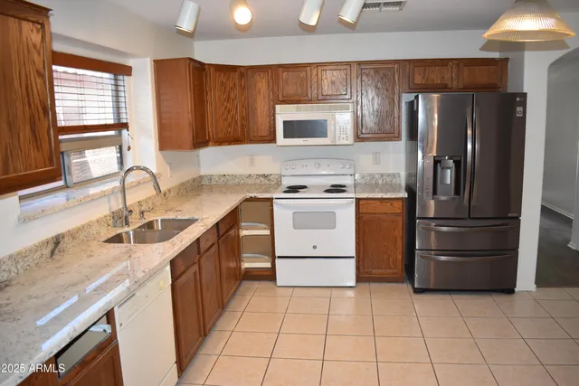 a kitchen with a stove sink and refrigerator