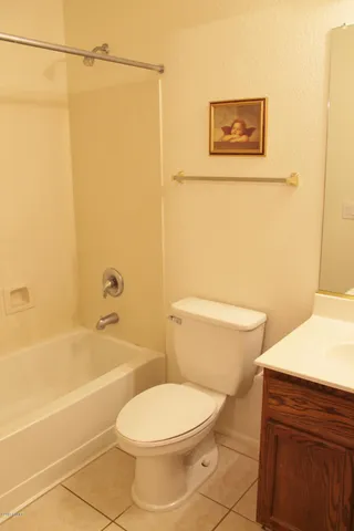a white toilet sitting next to a bath tub and a shower