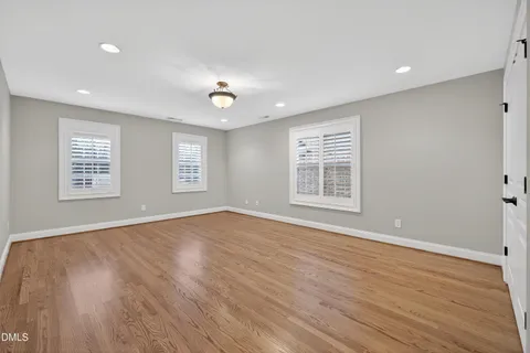 a view of a hallway with wooden floor and entryway