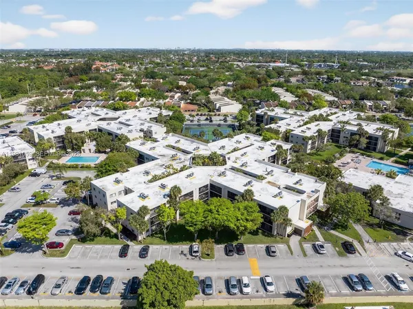 an aerial view of residential building with green space