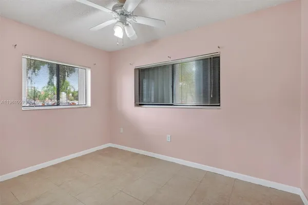 a view of a room with closet and chandelier fan
