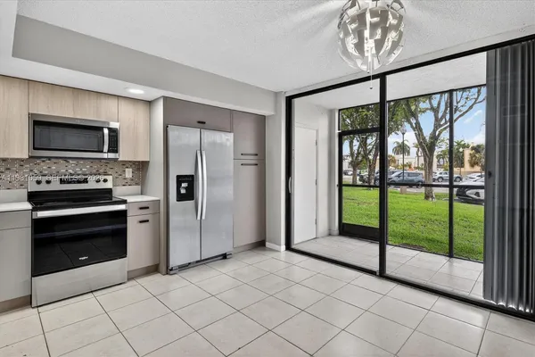 a kitchen with a stove and a refrigerator