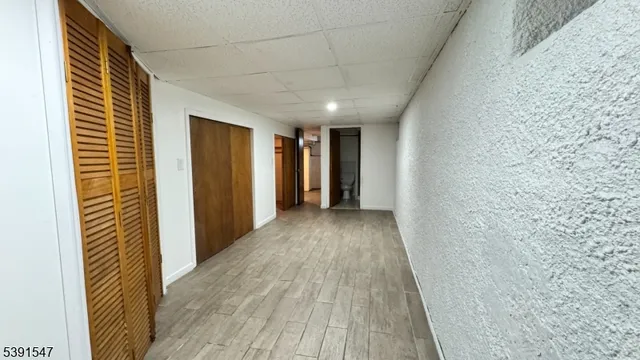 a view of hallway with wooden floor