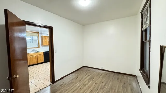 a view of walk in closet with wooden floor