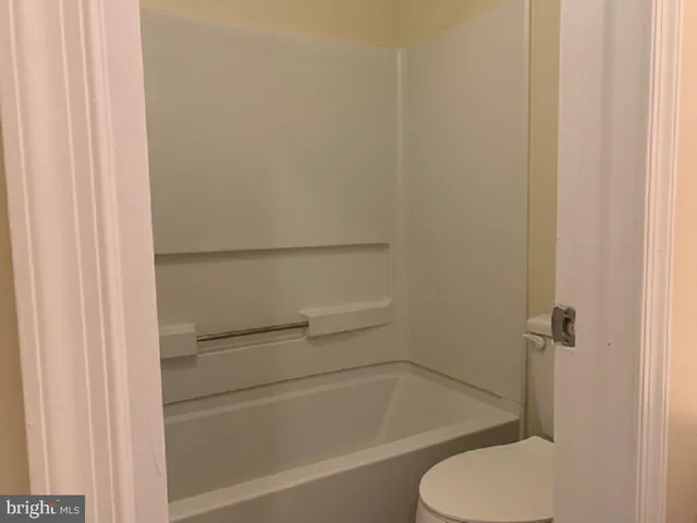 a view of a bedroom with brick walls and potted plants