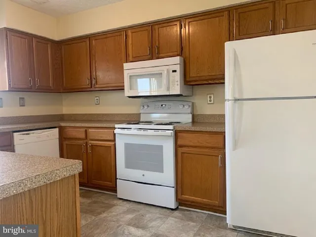 a kitchen with a sink a stove and a refrigerator