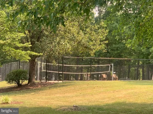 a view of a backyard with couches and swimming pool