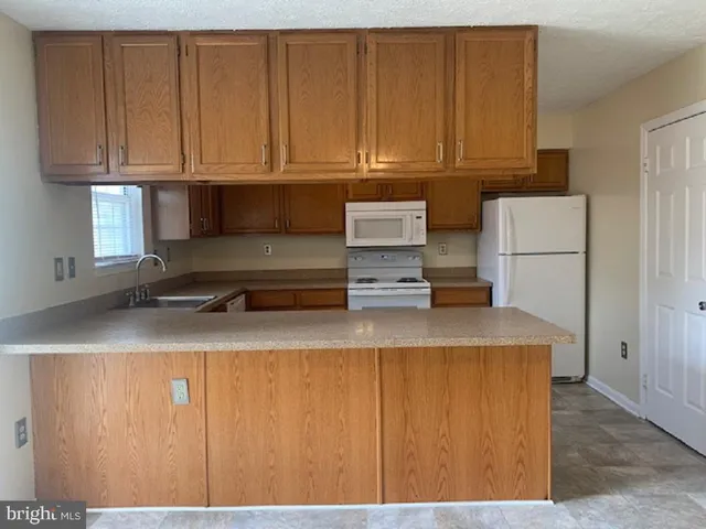 a kitchen with a sink a stove and refrigerator
