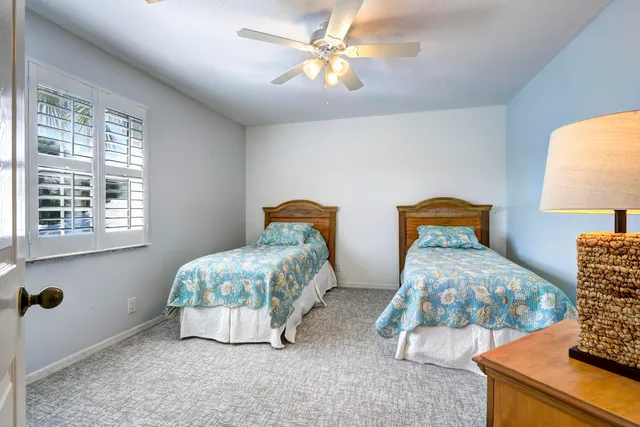 a bedroom with two beds and a window