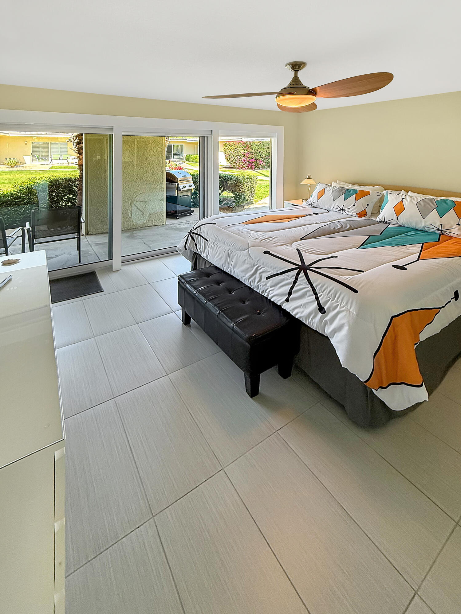 1881 South Araby Drive, Unit 16 Palm Springs, CA 92264 - Photo 18 of 52 a bedroom with a bed and glass windows