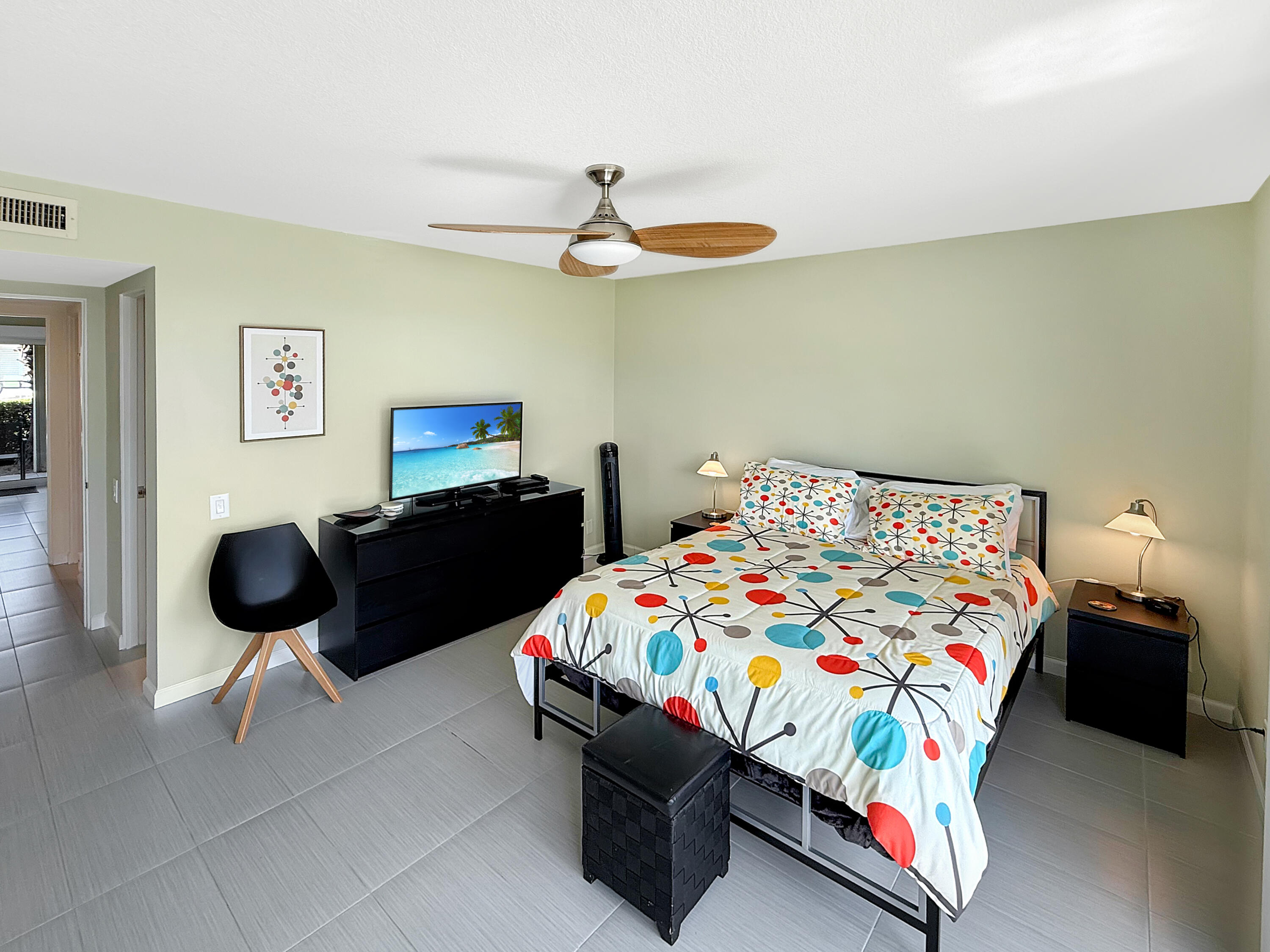 1881 South Araby Drive, Unit 16 Palm Springs, CA 92264 - Photo 23 of 52 a bedroom with a bed and a chandelier