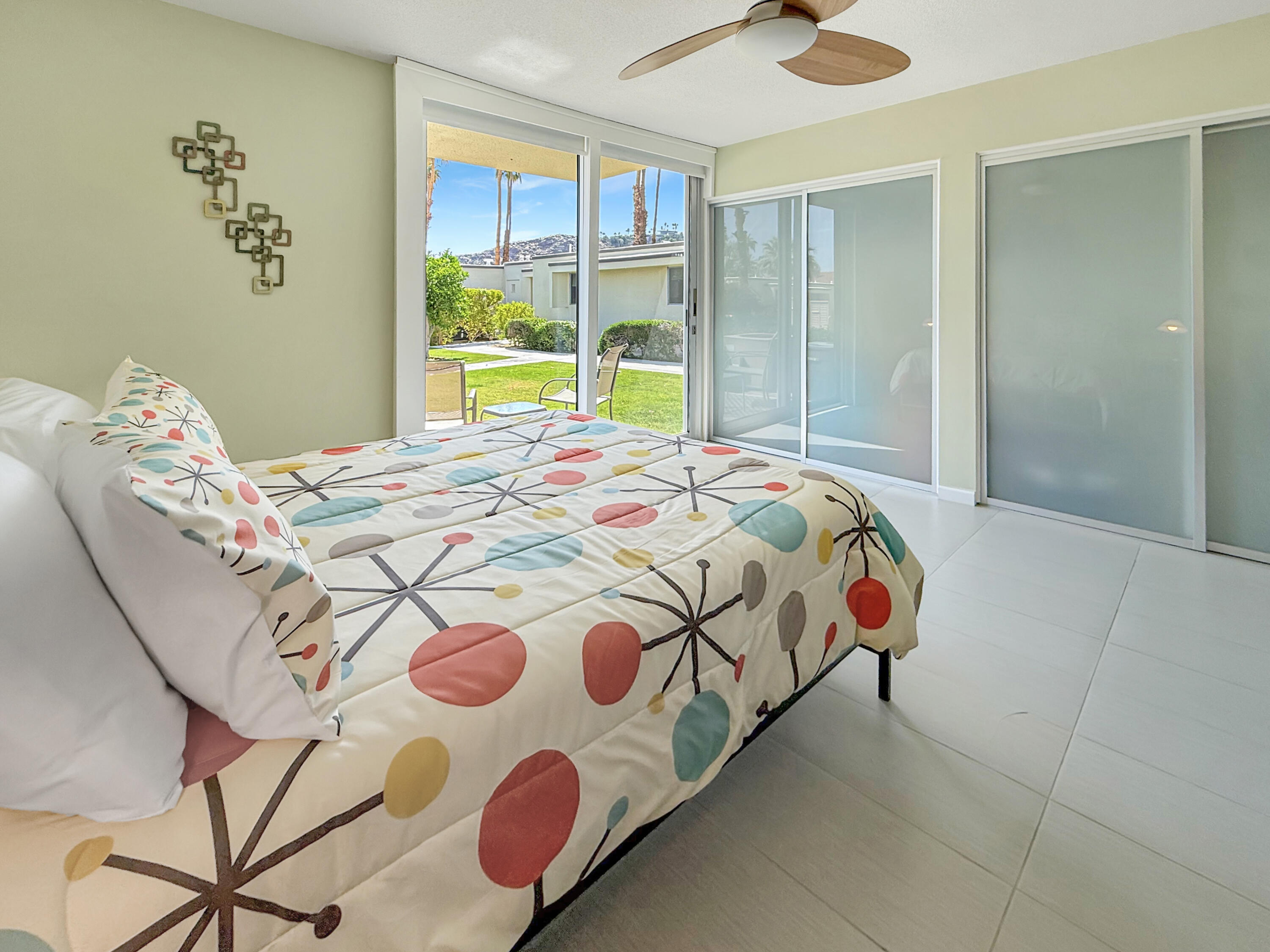 1881 South Araby Drive, Unit 16 Palm Springs, CA 92264 - Photo 25 of 52 a bedroom with a bed and a window