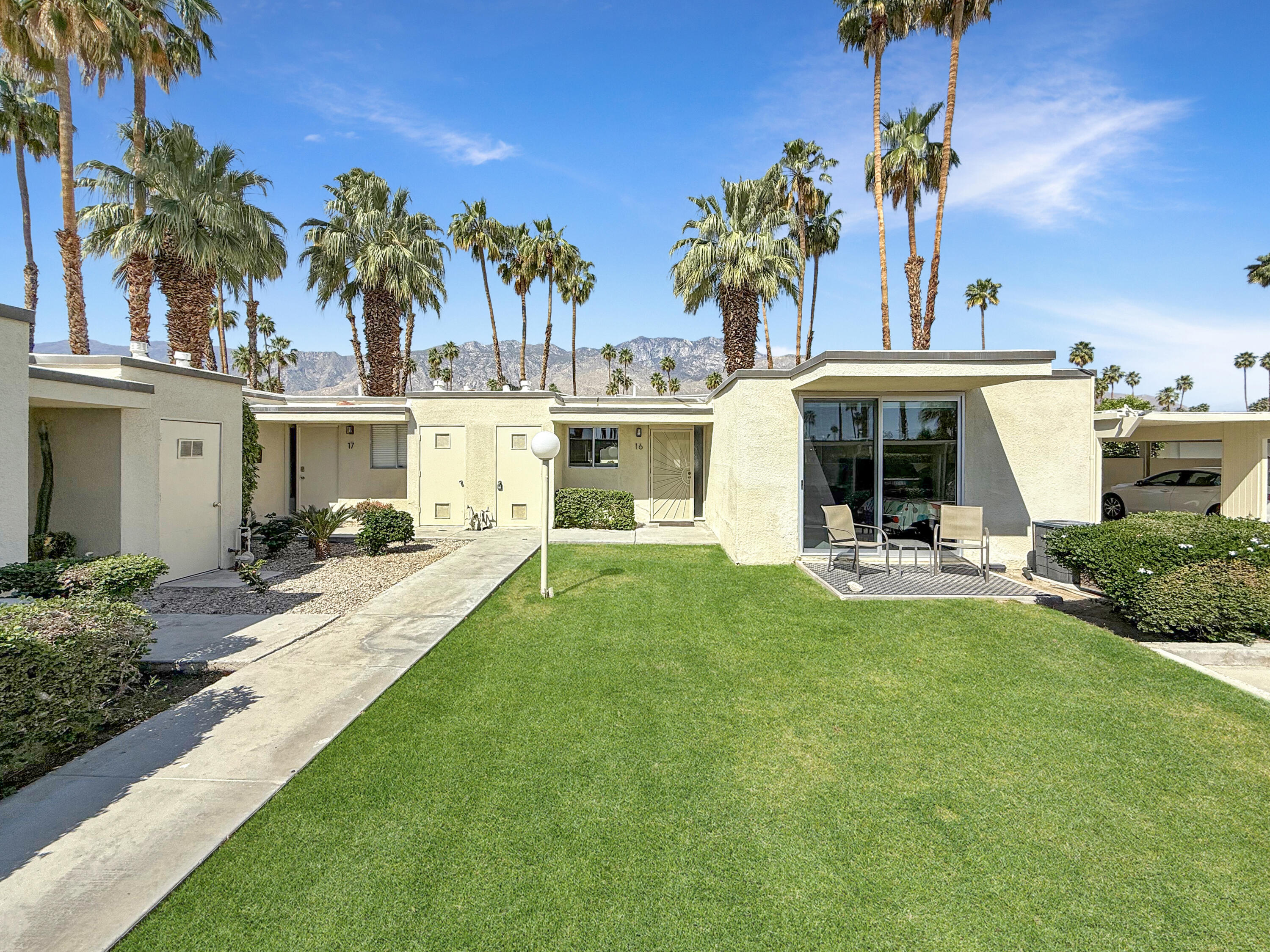 1881 South Araby Drive, Unit 16 Palm Springs, CA 92264 - Photo 28 of 52 a view of a house with a swimming pool and a patio