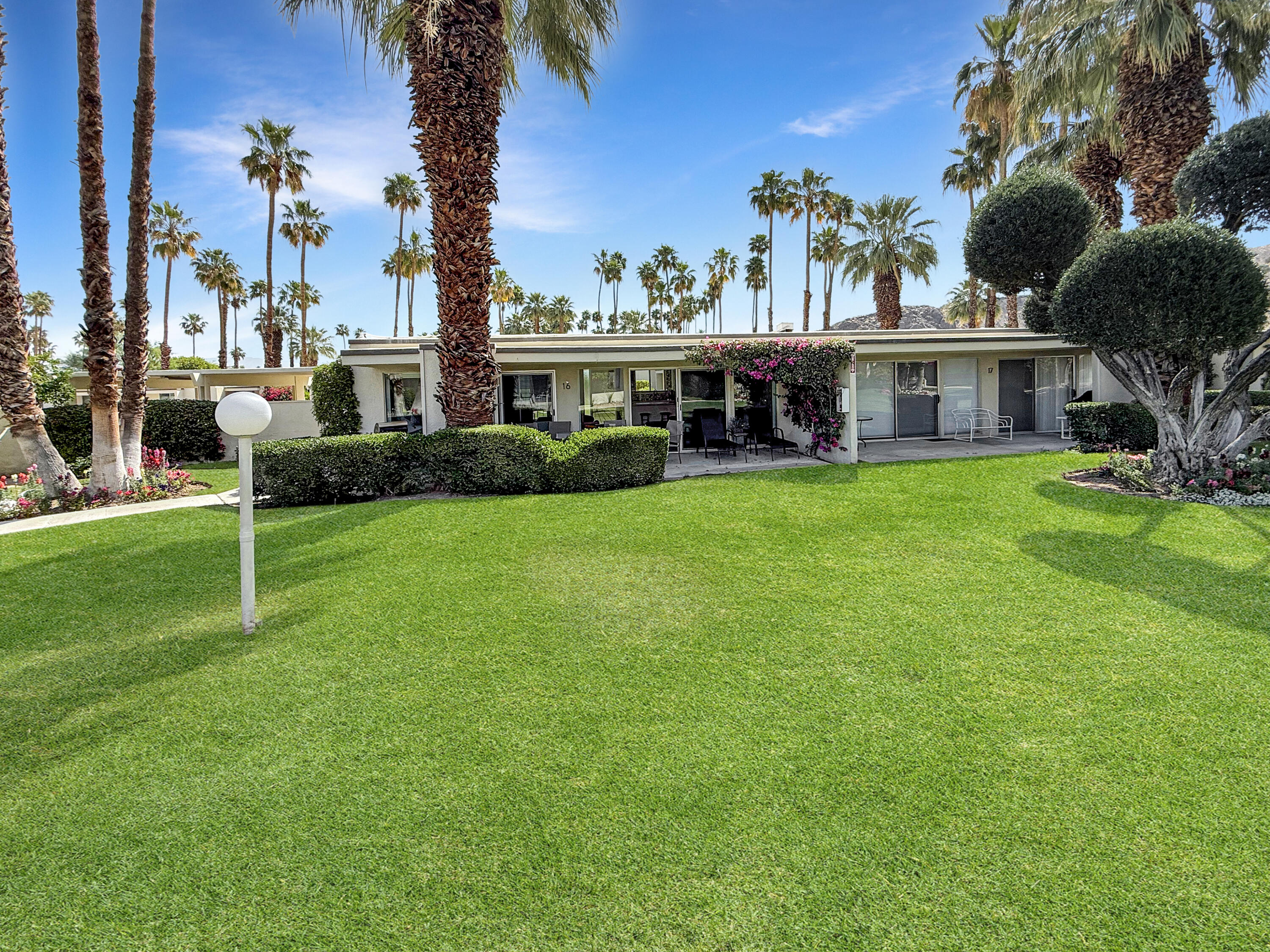 1881 South Araby Drive, Unit 16 Palm Springs, CA 92264 - Photo 30 of 52 a view of house with a big yard and potted plants